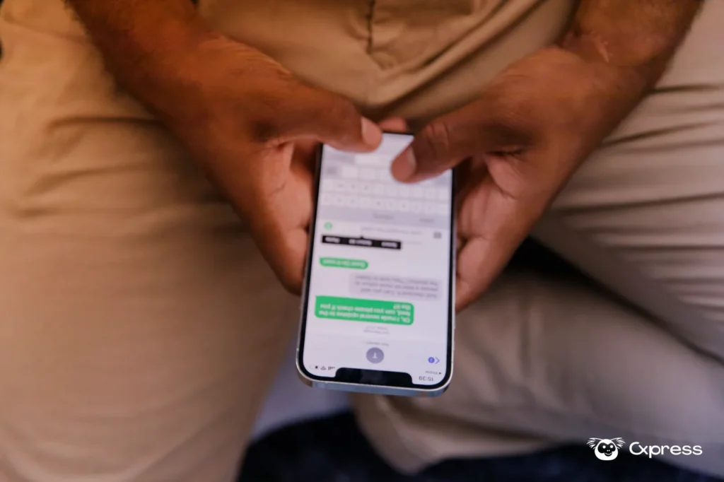 Pessoa segurando celular enquanto confere uma mensagem suspeita de atendimento bancário